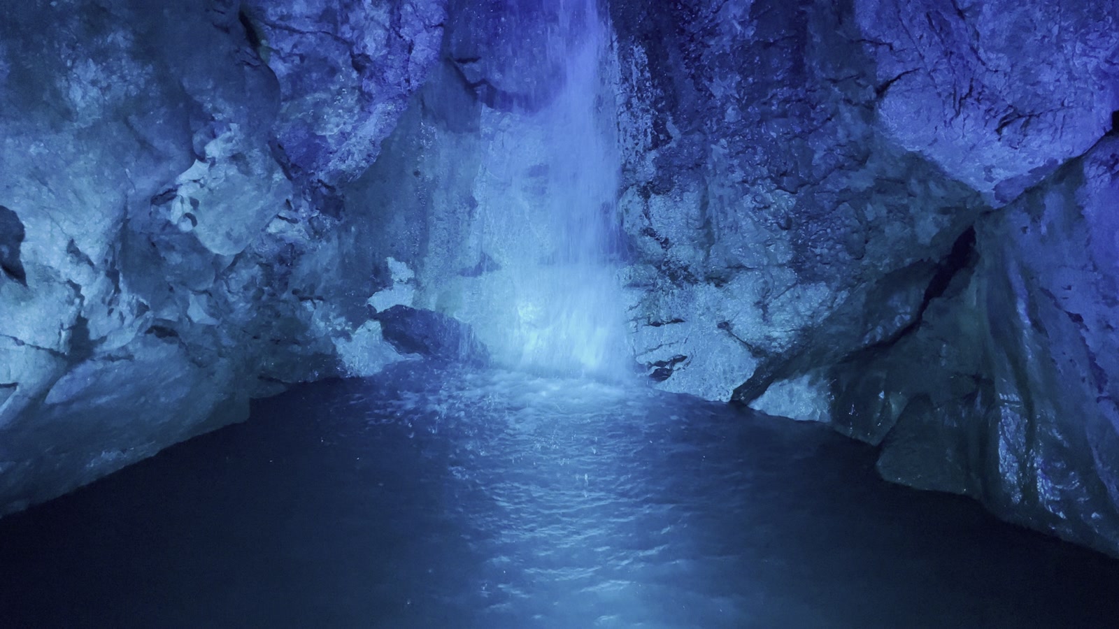 青い光に照らされた洞内の水辺